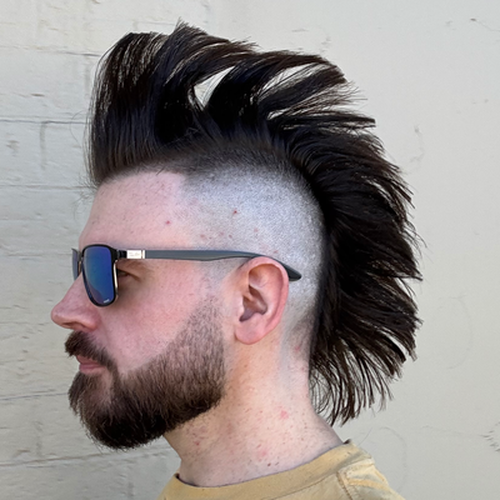 Profile Selfie of Anders Rasmussen. Looking to the left of frame. Sporting a mohawk.
